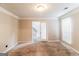 Bedroom with neutral carpet and paint, a bright window, and a door leading to the stairway at 3796 Wolverton Cir, Lithonia, GA 30038