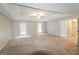 Expansive primary bedroom features neutral carpet, tray ceiling, and a ceiling fan at 3796 Wolverton Cir, Lithonia, GA 30038