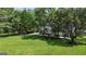 Expansive backyard with lush lawn, mature trees, playset, and outdoor seating area for relaxation at 127 Rockspray Rdg, Peachtree City, GA 30269