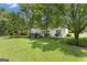Backyard features mature trees and outdoor seating area at 127 Rockspray Rdg, Peachtree City, GA 30269