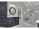 Elegant bathroom features a spacious glass shower, vanity with a dark cabinet, and marble accents at 127 Rockspray Rdg, Peachtree City, GA 30269
