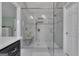 A luxurious bathroom with a glass shower, marble walls and a bench at 127 Rockspray Rdg, Peachtree City, GA 30269