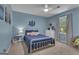 Lovely bedroom with blue walls, white furniture, and a comfortable bed and chair at 127 Rockspray Rdg, Peachtree City, GA 30269