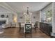 Elegant dining room featuring a modern chandelier and wood floors at 127 Rockspray Rdg, Peachtree City, GA 30269