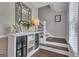 Charming entryway with a decorative console table, fresh flowers, and a welcoming staircase at 127 Rockspray Rdg, Peachtree City, GA 30269