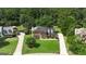 Charming two-story brick home with a well-manicured lawn and driveway surrounded by lush trees at 127 Rockspray Rdg, Peachtree City, GA 30269