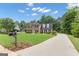 A charming two-story home with a long drive, beautiful yard and lush trees at 127 Rockspray Rdg, Peachtree City, GA 30269