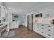 Spacious kitchen with white cabinets, stainless steel appliances and wood floors offers modern style at 127 Rockspray Rdg, Peachtree City, GA 30269