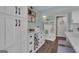 Bright kitchen features white cabinetry, wine rack, and a stylish entryway organizer at 127 Rockspray Rdg, Peachtree City, GA 30269