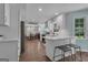 Modern kitchen with white cabinets, stainless steel appliances, and a breakfast bar at 127 Rockspray Rdg, Peachtree City, GA 30269