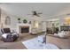 A cozy living room with a fireplace, ceiling fan, and new flooring at 127 Rockspray Rdg, Peachtree City, GA 30269
