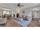 Spacious open-concept living and dining area with modern lighting and wood floors at 127 Rockspray Rdg, Peachtree City, GA 30269