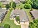 Aerial view of home showcasing landscaped yard, mature trees, and a two car garage at 409 Brandy Ln, Mcdonough, GA 30253