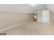 Attic area with wall-to-wall carpeting, neutral walls, a door and a descending stairway at 409 Brandy Ln, Mcdonough, GA 30253
