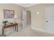 Cozy bedroom featuring neutral walls, a side table with flower art, and an open doorway at 409 Brandy Ln, Mcdonough, GA 30253