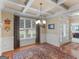 Elegant dining room featuring a coffered ceiling, large window, hardwood floors, and a chandelier at 409 Brandy Ln, Mcdonough, GA 30253