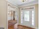 Inviting foyer with hardwood floors, decorative front door, and an open view into the dining room at 409 Brandy Ln, Mcdonough, GA 30253
