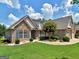A beautiful home with stone and siding, a well-kept lawn, flowering tree and manicured landscaping at 409 Brandy Ln, Mcdonough, GA 30253
