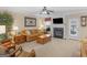 Comfortable living room boasts a fireplace, neutral tones, and a ceiling fan at 409 Brandy Ln, Mcdonough, GA 30253