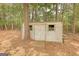 Outdoor shed with a wooden ramp and lattice accent on siding at 70 Summer Walk Dr, Covington, GA 30016