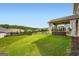 Expansive backyard with manicured lawn, fencing, and a covered patio at 5915 Partners Pass, Cumming, GA 30028