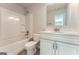 Clean bathroom featuring a tub/shower combo and white vanity with a mirror at 5915 Partners Pass, Cumming, GA 30028