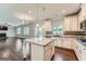 Bright kitchen boasts granite counters, island, stainless appliances, and is open to the living room at 5915 Partners Pass, Cumming, GA 30028