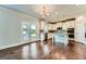 Bright kitchen features white cabinets, granite countertops, stainless appliances, and outdoor access at 5915 Partners Pass, Cumming, GA 30028