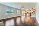 Living room featuring hardwood floors, stairs to the second story, and open to the kitchen at 5915 Partners Pass, Cumming, GA 30028