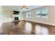 Spacious living room with fireplace, built-in shelving, ceiling fan, and gleaming hardwood floors at 5915 Partners Pass, Cumming, GA 30028