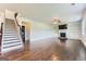 Living room with hardwood floors, fireplace, built-in shelving, and stairs at 5915 Partners Pass, Cumming, GA 30028
