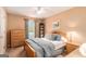 Cozy bedroom with a wood bed frame, dresser, nightstand, and a ceiling fan for comfort at 85 London Ln, Sharpsburg, GA 30277