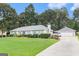 Wide view of the front exterior of a charming house with a well-manicured lawn and a detached garage at 85 London Ln, Sharpsburg, GA 30277