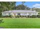 Charming single-story home featuring a manicured lawn and nicely trimmed shrubs at 85 London Ln, Sharpsburg, GA 30277