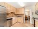 A cozy kitchen features wooden cabinets, tile floors, stainless steel appliances, and an adjacent dining area at 85 London Ln, Sharpsburg, GA 30277