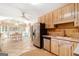 Well-lit kitchen featuring stainless steel appliances, light wood cabinetry, and an adjacent dining area at 85 London Ln, Sharpsburg, GA 30277
