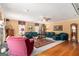 Bright living room with hardwood floors, plush seating, a ceiling fan, and elegant decor at 85 London Ln, Sharpsburg, GA 30277