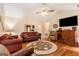 Comfortable living room with hardwood floors, a ceiling fan, and a view into the dining area at 85 London Ln, Sharpsburg, GA 30277