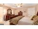 A well-lit main bedroom boasts carpet, a dresser with a mirror, and a classic wooden bed frame at 85 London Ln, Sharpsburg, GA 30277