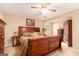 A main bedroom with warm colors features a wooden bed frame, carpet, and wood furniture at 85 London Ln, Sharpsburg, GA 30277