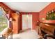 An office features a globe, vintage desk, and a window view with warm, inviting, red walls at 85 London Ln, Sharpsburg, GA 30277