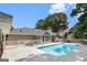 Beautiful backyard pool with a large patio, privacy fence, and mature trees at 85 London Ln, Sharpsburg, GA 30277