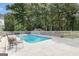 Backyard featuring an in-ground pool, a patio area, and lush greenery at 85 London Ln, Sharpsburg, GA 30277