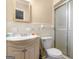 Cozy bathroom featuring a shower, decorative mirror, and white tile flooring at 3 Ridge Dr, Hampton, GA 30228