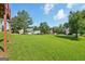 Expansive grassy backyard, showcasing mature trees and neighboring houses, perfect for outdoor activities at 2326 Sand Dollar Sw Ct, Atlanta, GA 30331