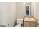 Powder room with a vanity, sink, toilet, and mirror at 2326 Sand Dollar Sw Ct, Atlanta, GA 30331