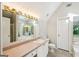 Bright bathroom featuring vanity with a sink and a large mirror with decorative lighting, plus a tiled floor at 2326 Sand Dollar Sw Ct, Atlanta, GA 30331