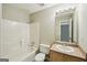 Bathroom with shower-tub combo, updated sink, and a large vanity mirror at 2326 Sand Dollar Sw Ct, Atlanta, GA 30331