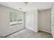 Bedroom with a large window and closet featuring neutral colors and carpet flooring at 2326 Sand Dollar Sw Ct, Atlanta, GA 30331