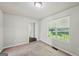 A sunny bedroom with a window featuring views of the yard at 2326 Sand Dollar Sw Ct, Atlanta, GA 30331